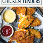 Overhead shot of a tray of baked chicken tenders with text title box at top