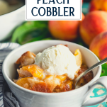 Side shot of a bowl of peach cobbler with vanilla ice cream with text title overlay