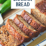 Sliced loaf of zucchini banana bread with text title overlay