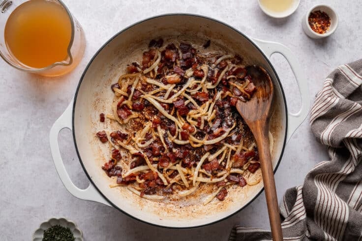 Frying bacon in a cast iron skillet.