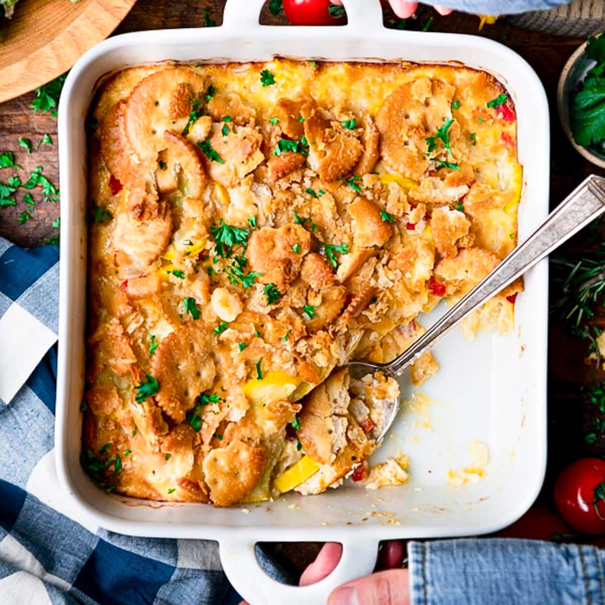 Square overhead shot of the best southern squash casserole recipe in a white dish.