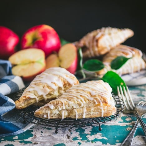 Square featured image of a apple turnovers on a cooling rack