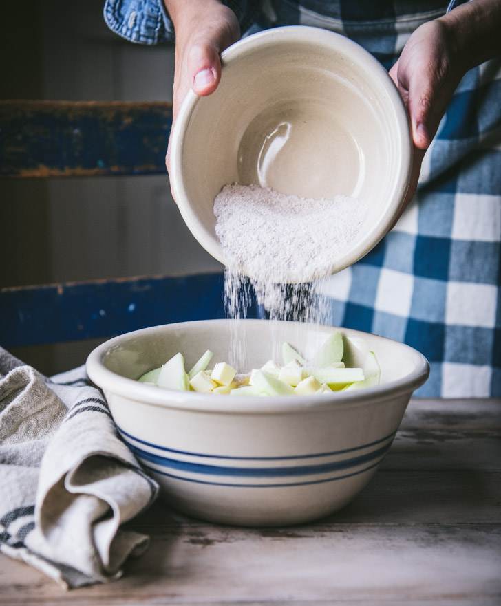 Stirring together apple filling in large bowl