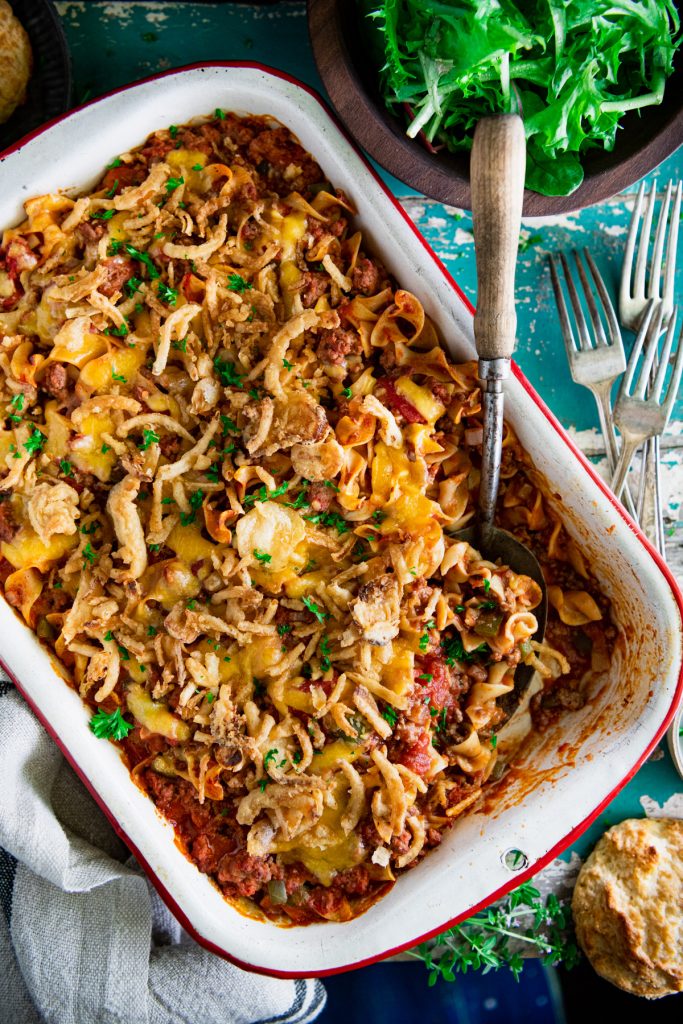 Close overhead shot of an easy beef noodle casserole on an antique wooden table