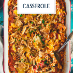 Overhead shot of a pan of beef noodle casserole with text title overlay