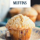 Side shot of a blackberry muffin on a plate with text title overlay