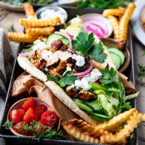 Close up side shot of a chicken shawarma pita on a tray