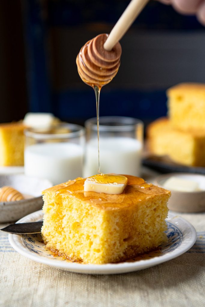 Drizzling honey on a slice of cake mix cornbread