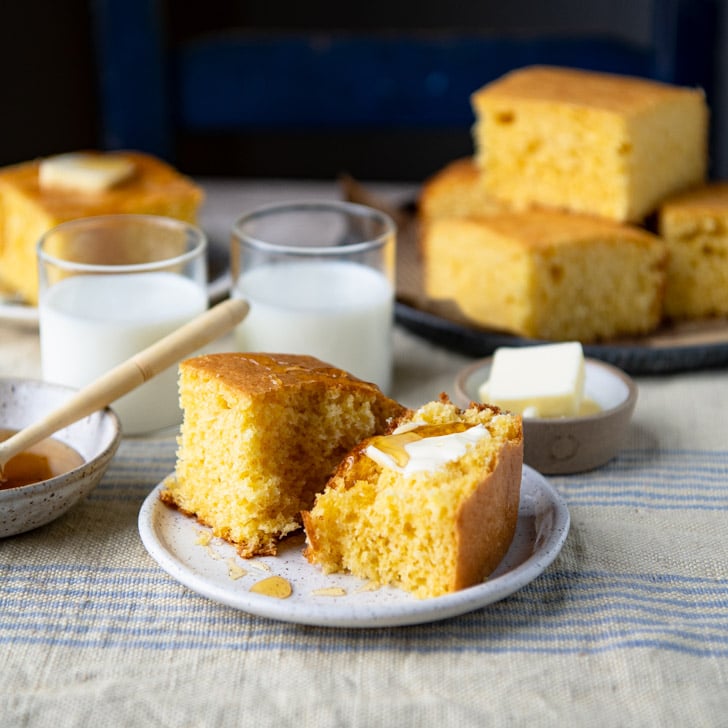 Buttered slice of cornbread on a plate