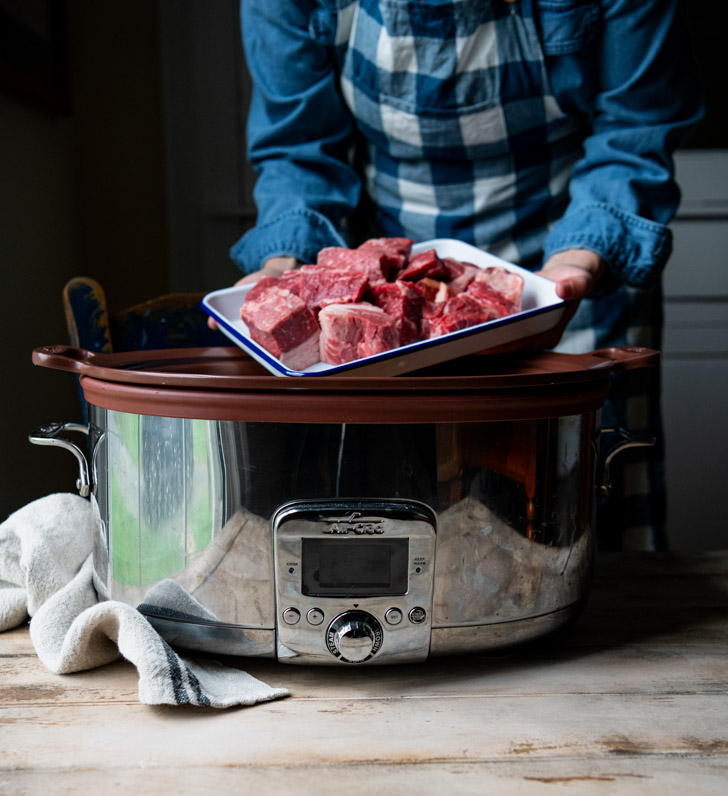 Adding chunks of beef chuck roast to a slow cooker