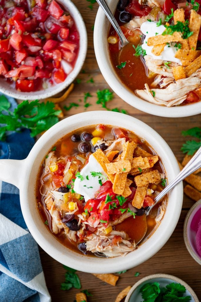 Close overhead image of easy chicken tortilla soup on a wooden table