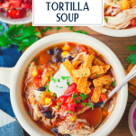 Close overhead image of crock pot chicken tortilla soup with text title overlay