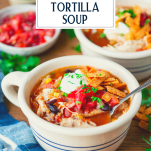 Side shot of a bowl of chicken tortilla soup with text title overlay