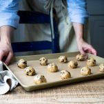 Cookie dough balls on baking sheet.
