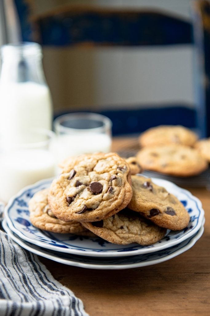 Plate of easy chocolate chip cookies with milk in the background