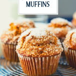 Pumpkin muffins cooling on a wire rack with text title overlay