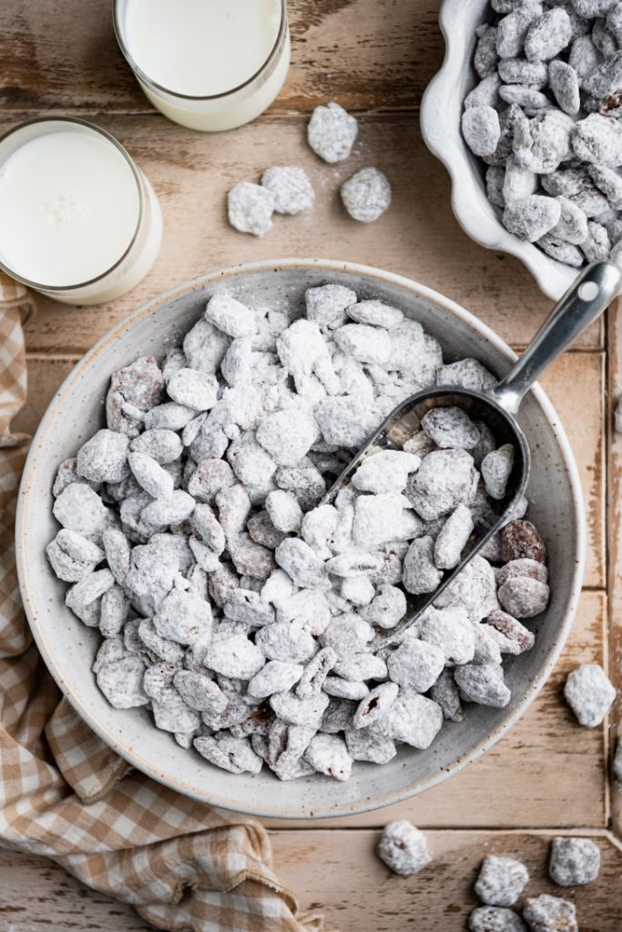 Overhead image of a bowl of muddy buddies on a wooden table