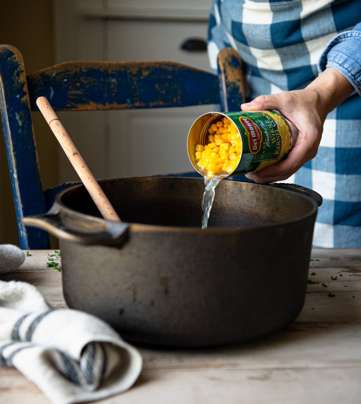 Adding canned corn to a pot