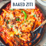 Close overhead shot of a pan of vegetable and cheese baked ziti with text title overlay