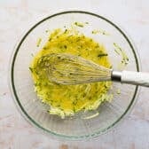 Combining zucchini, oil, eggs, and vanilla in a bowl.