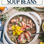 Overhead shot of a bowl of appalachian soup beans or pinto bean soup with text title box at top
