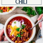 Overhead shot of a bowl of beer chili with text title box at top