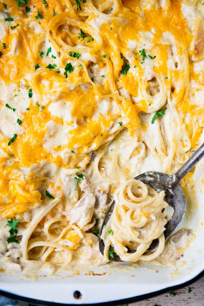 Close overhead image of a spoon in a dish of easy chicken tetrazzini