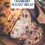 Sliced loaf of cranberry walnut no knead bread with text title overlay