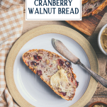 Slice of cranberry walnut bread with text title overlay