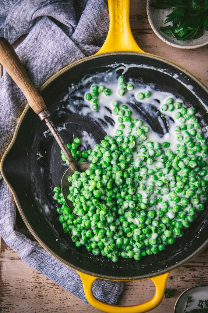 Overhead shot of a skillet of creamed peas