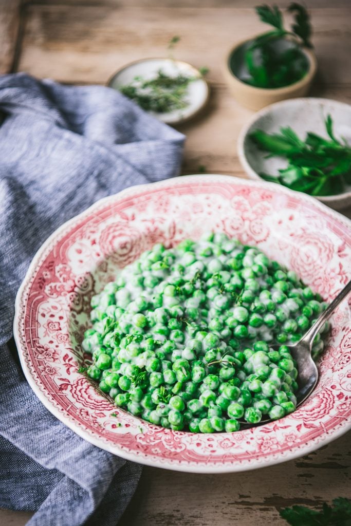 Side shot of a bowl of old fashioned creamed peas