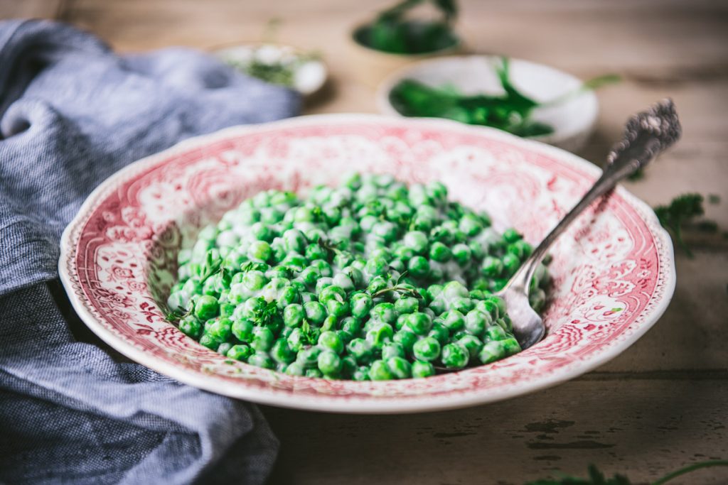 Horizontal shot of a bowl of creamed peas