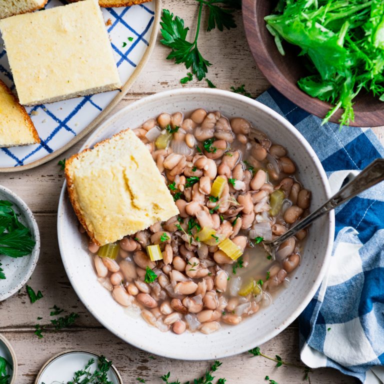 Square overhead shot of Crock Pot beans and cornbread with a side salad