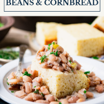 Side shot of crock pot beans and cornbread on a plate with text title box at top