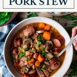 Overhead shot of a bowl of pork stew with text title box at top