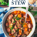 Overhead shot of a bowl of pork stew with text title overlay