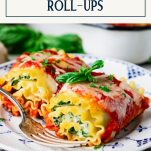 Plate of spinach lasagna roll ups with text title box at top
