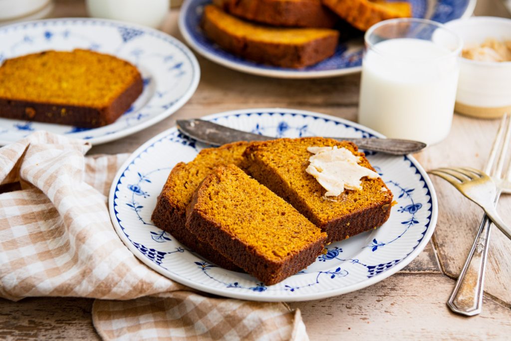 Horizontal image of a plate of pumpkin bread on a table