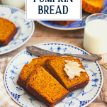 Pumpkin bread on a plate with text title overlay