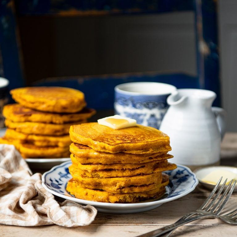 Square side shot of a stack of pumpkin pancakes on a breakfast table