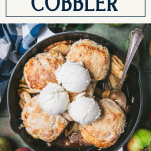 Overhead shot of a skillet of apple cobbler with text title box at top