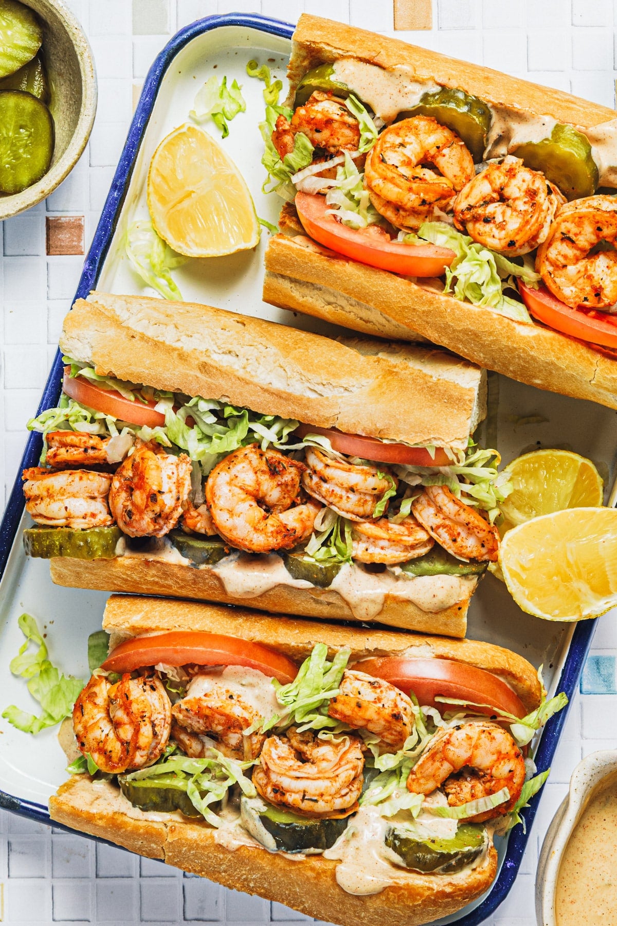 Overhead shot of a tray of shrimp po boys.