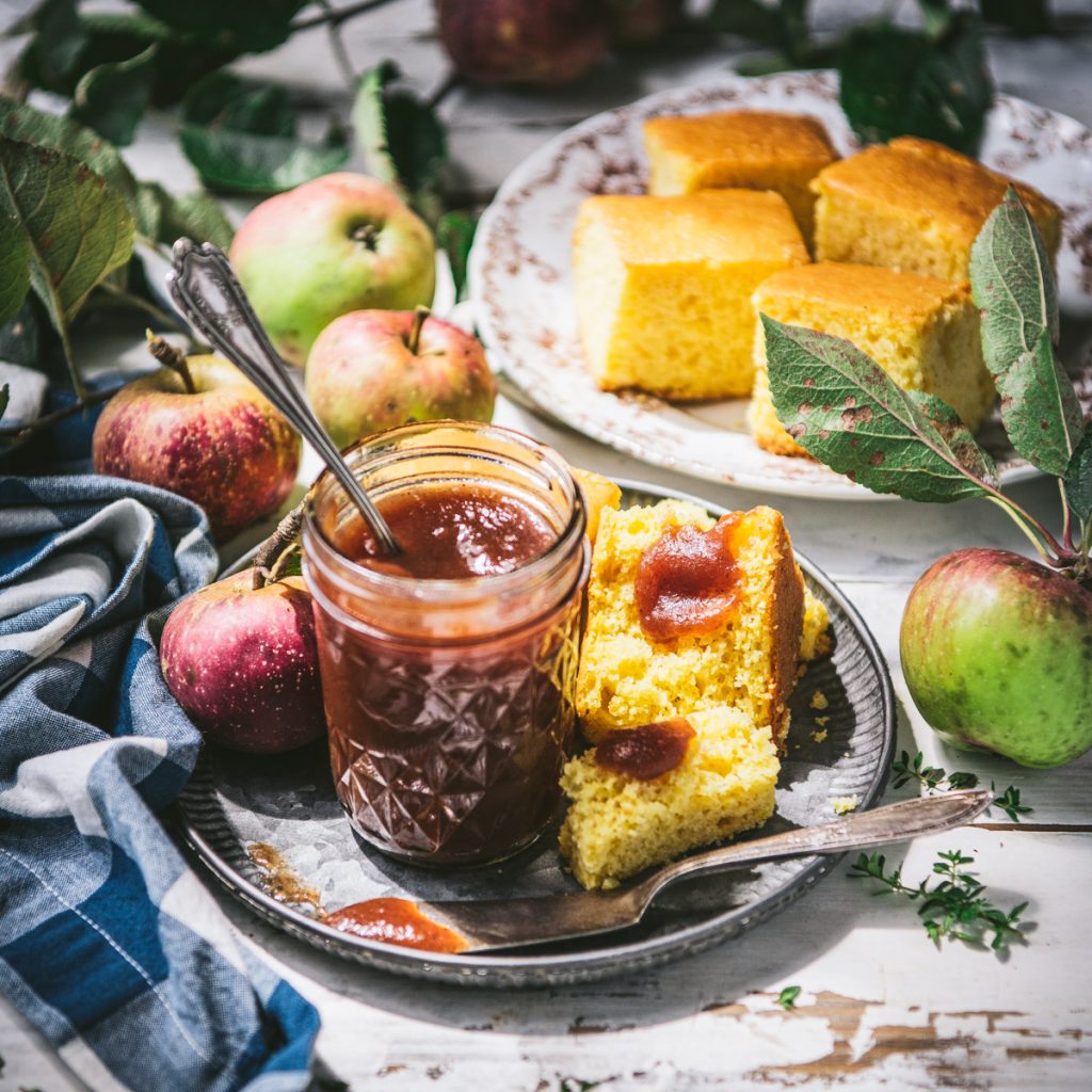 Square side shot of a table with apple butter and cornbread