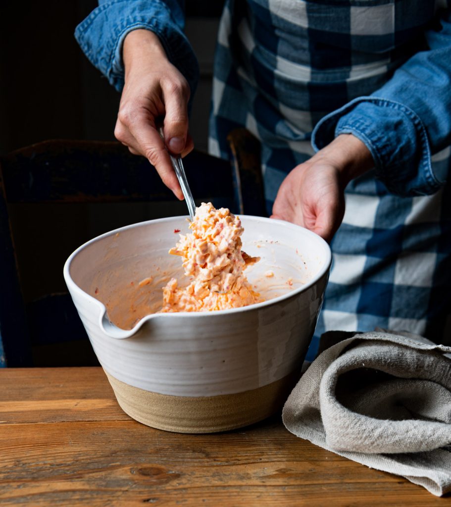 Pimento cheese spread in a white mixing bowl
