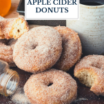 Wooden board of baked apple cider donuts with text title overlay