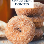Close up shot of stacked baked apple cider donuts with text title overlay