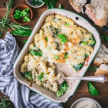 Square overhead shot of a pan of broccoli and cheese Alfredo pasta bake