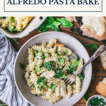 Bowl of alfredo pasta bake with text title box at top