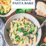 Bowl of broccoli cheese alfredo pasta bake with text title overlay