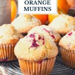 Cranberry orange muffins on a cooling rack with text title overlay